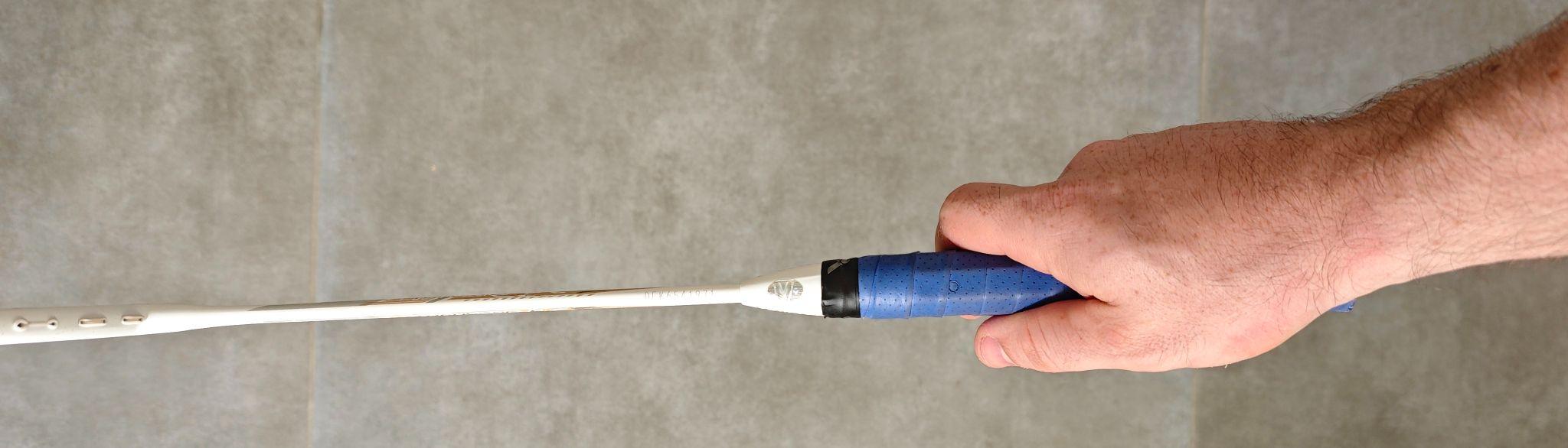 Hand holding a racket with a basic V grip